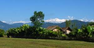 A tribal village with snow mountains in the back drop